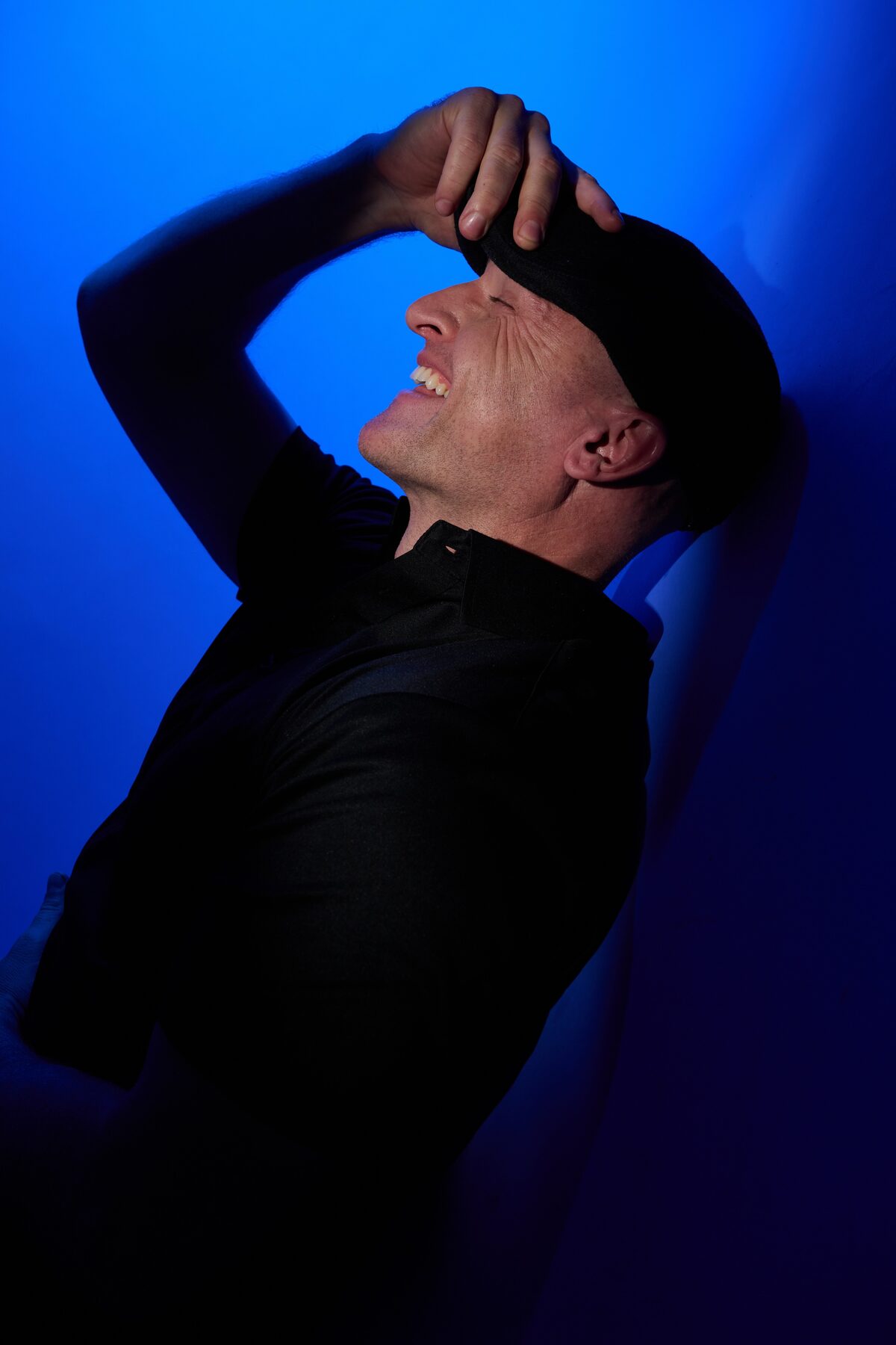 Introspective blue-lit portrait of Matthew Mayer