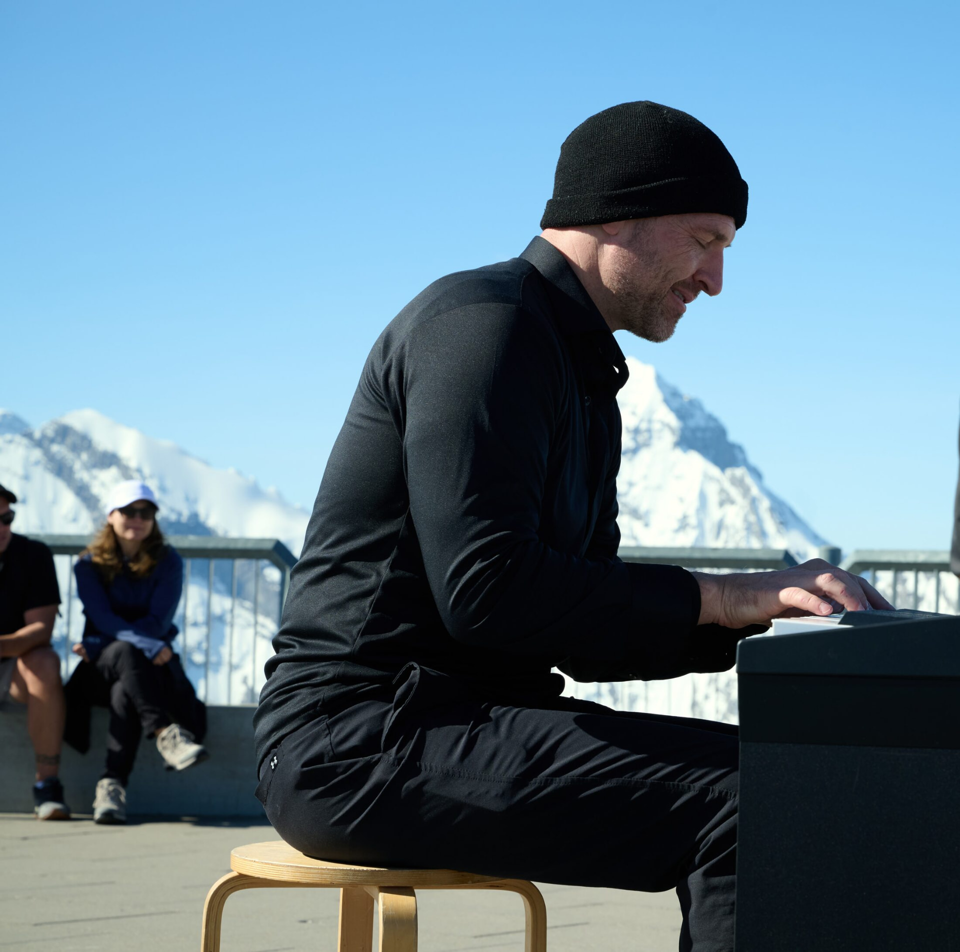 Matthew Mayer playing piano on the Schilthorn summit terrace