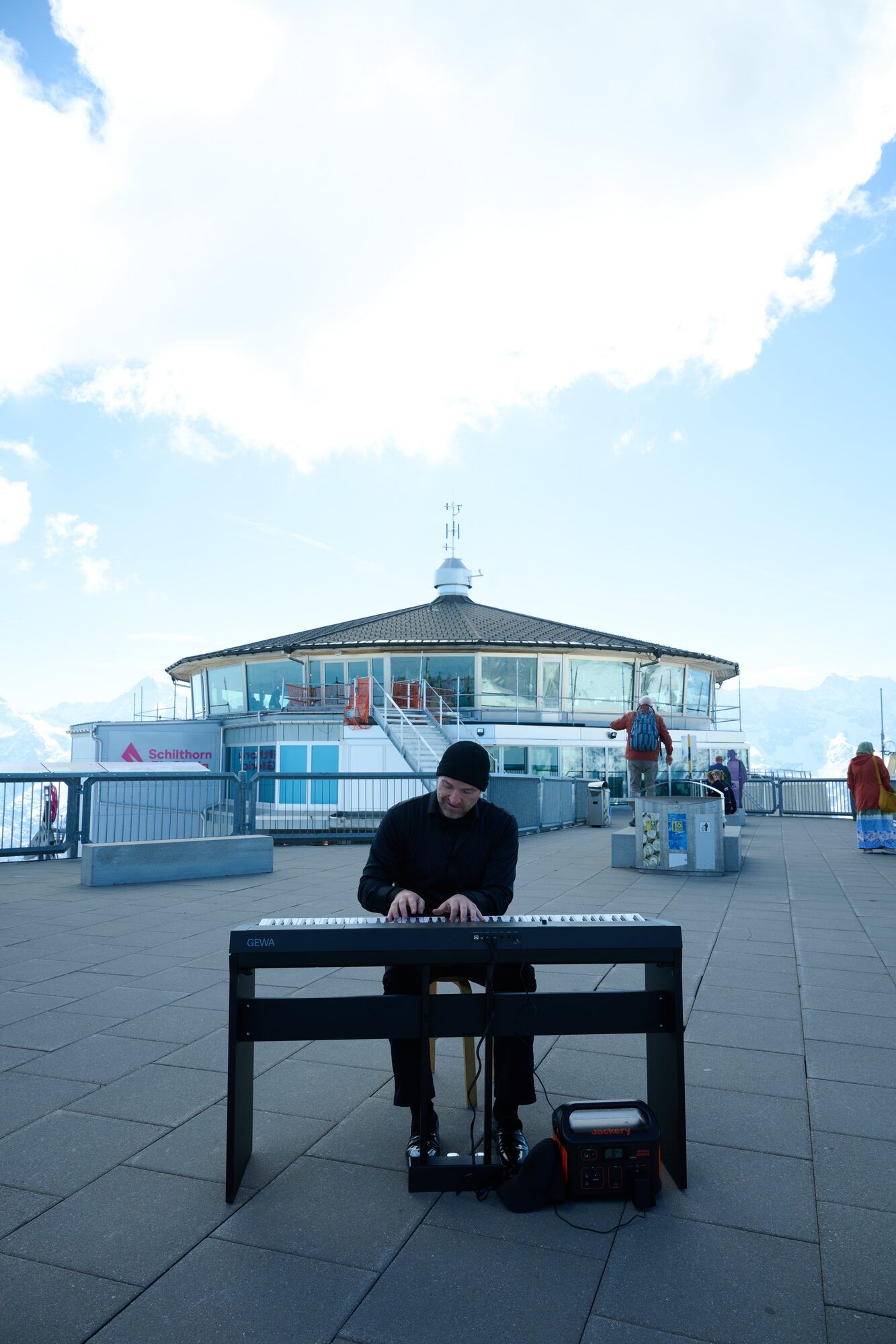 Matthew Mayer performing piano high above the Swiss Alps at the Schilthorn